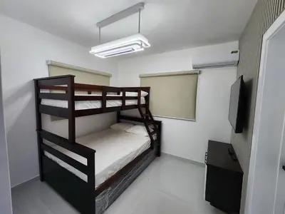 a bedroom with two bunk beds and a television at Villa M & M in Guerra