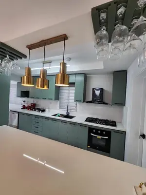a kitchen with mint green cabinets and lights at Villa M & M in Guerra
