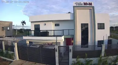 a white building with a gate in front of it at Villa M & M in Guerra