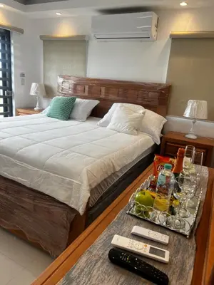 a bedroom with a bed and a tray of food on a table at Villa M & M in Guerra