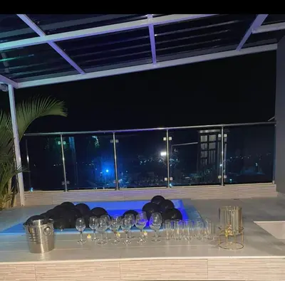 a bunch of wine glasses sitting on a table with a view at Nice rooftop apartment in La Cabirma