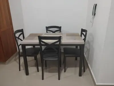 a dining room table with black chairs around it at Alojamiento Residencial MAM in San Cristóbal