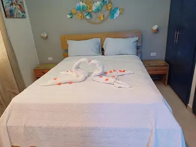 two swans towels are laying on a bed at Dominique ugolin in Mata Chalupe