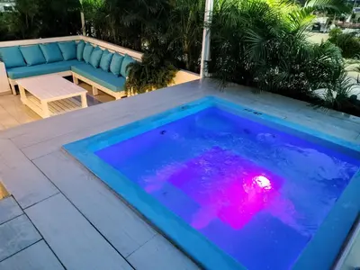 a swimming pool with a table and a couch at Dominique ugolin in Mata Chalupe