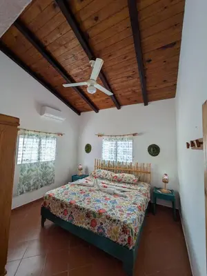 a bedroom with a bed with a wooden ceiling at Casa los Mangos Private pool 150 m from the beach in Las Galeras