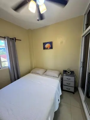a bedroom with a bed and a ceiling fan at Cielo Alto in Jarabacoa
