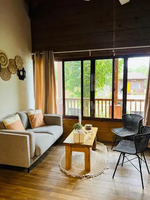 a living room with a couch and a coffee table at Estaciones de Jarabacoa-Mountain Lodge in Jarabacoa