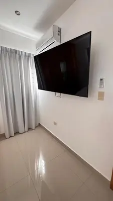 a living room with a flat screen tv on a wall at Coastal Apt, Near Malecón, 6 Guests 3 beds in La Romana
