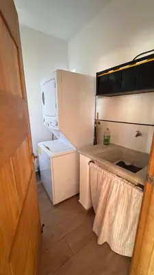 a small kitchen with a refrigerator and a sink at Coastal Apt, Near Malecón, 6 Guests 3 beds in La Romana