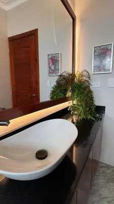 a bathroom with a white sink and a mirror at Luxury Caribbean Oasis, Private Pool & BBQ, 8 Guest in La Romana
