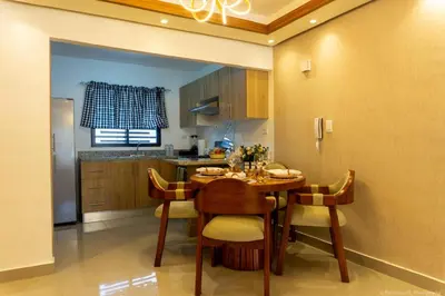 a kitchen with a table and chairs in a room at Apartamento Ensanche Isabelita cercano Avenida España in La Viva