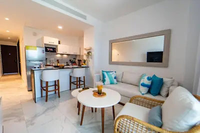a living room with a couch and a table at Refugio Ideal Golf & Piscina Cana Rock Star in Punta Cana