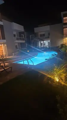 an empty swimming pool at night with lights at Luxury apto 3 rooms Mariel III at White Sand, Punta Cana in Punta Cana