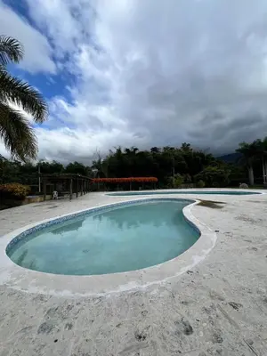 a small pool of water in the middle of a beach at Estaciones de Jarabacoa - Mountain Lodge in Jarabacoa