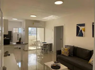 a living room and kitchen with a couch and a table at Fully furnished 2 bedroom appart in Bayahibe