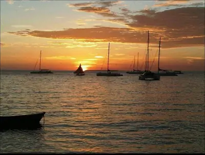 a group of boats in the water at sunset at Fully furnished 2 bedroom appart in Bayahibe