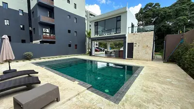 a swimming pool in the backyard of a house at 3BR Condo by the Airport Pool Gym Parking Security in Santiago de los Caballeros