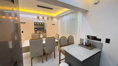 a kitchen and dining room with a table and chairs at 3BR Condo by the Airport Pool Gym Parking Security in Santiago de los Caballeros