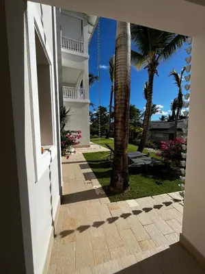 an open doorway to a building with palm trees at Sunset Paradise Tracadero Apartment Sea pools access Private Garden WorkSpace in La Laguna