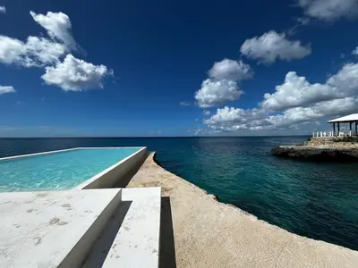 a view of the ocean from a house on the beach at Sunset Paradise Tracadero Apartment Sea pools access Private Garden WorkSpace in La Laguna