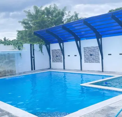 a swimming pool with a blue canopy over it at villa la pal de 4 in La Ureña
