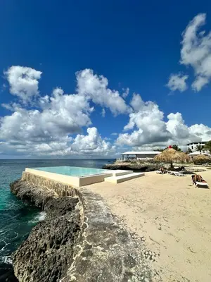 a beach with a swimming pool and the ocean at 1BR Tracadero Lodge, beach access & full amenities in La Laguna