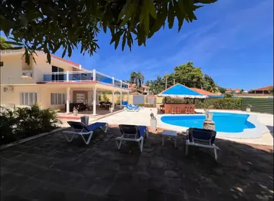 a villa with a swimming pool and a resort at Villa Us Open in Sosúa