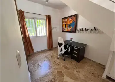 a office with a desk and a chair in a room at Villa Us Open in Sosúa