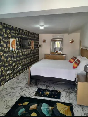 a bedroom with a large white bed and a rug at Villa Us Open in Sosúa