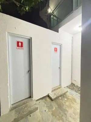 two doors in a wall with signs on them at Villa la pal de 4 in La Ureña