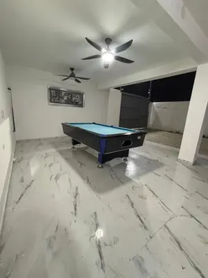 a pool table in a room with a ceiling fan at Villa la pal de 4 in La Ureña