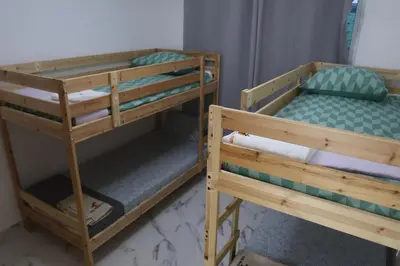 two wooden bunk beds in a room withthritisthritisthritisthritisthritisthritisthritisthritis at Villa Yvelisse Pop Un paraíso próximo al Mar in San Felipe de Puerto Plata