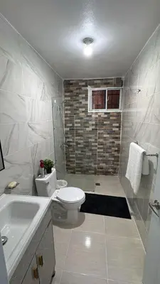 a bathroom with a toilet and a shower and a sink at Spacious 3BR Getaway in Santiago