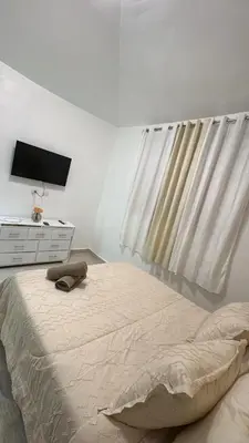 a bedroom with a bed with a television and a dresser at Spacious 3BR Getaway in Santiago
