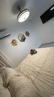 a bedroom with a bed and a light on the wall at Spacious 3BR Getaway in Santiago