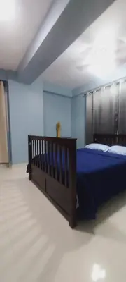 a bedroom with a bed and blue walls at Cozy & Charming in Santo Domingo