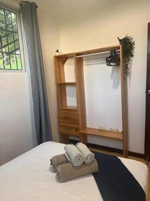 a bedroom with a bed with towels and a window at La Española JW in Las Galeras