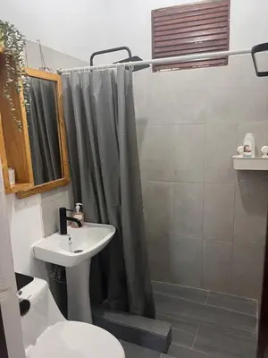a bathroom with a shower curtain and a sink at La Española JW in Las Galeras