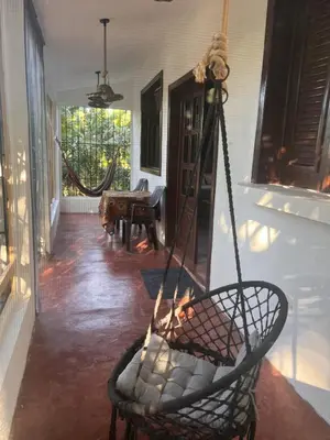 a porch with a swing in a room at La Española JW in Las Galeras