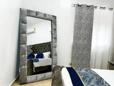 a mirror in a bedroom with a bed at Haven Villa Retreat Jacuzzi Oasis for 16 in Mata los Indios