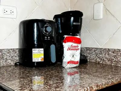 a bottle of ketchup sitting on a counter next to a coffee maker at Haven Villa Retreat Jacuzzi Oasis for 16 in Mata los Indios