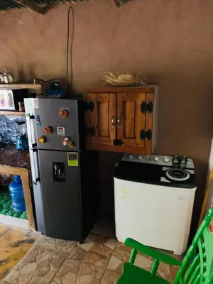 a kitchen with a refrigerator and a stove at Villa el privilegio in Jarabacoa