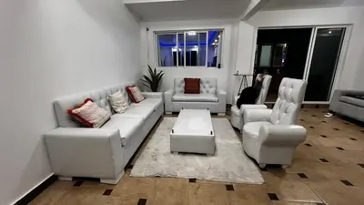 a living room with a white couch and chairs at Villa Robilu