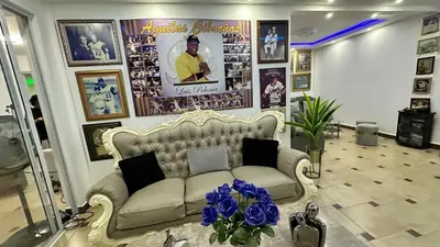 a living room with a couch and pictures on the wall at Villa Robilu