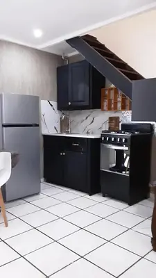 a kitchen with a black and white counter top at Tortuga Cabarete Resindencial in Sosua