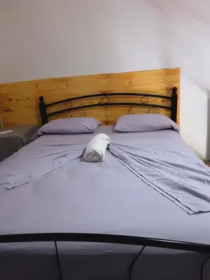 a bed with a head board and pillows on it at Tortuga Cabarete Resindencial in Sosua