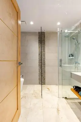 a bathroom with a glass shower and a toilet at Modern Oceanview Retreat with Balcony and Walk to Bay in Santa Bárbara de Samaná
