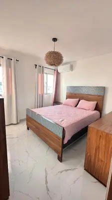 a bedroom with a bed with pink sheets and pink pillows at VILLA 127 La Intensa Del Caribe in Pueblo Bavaro