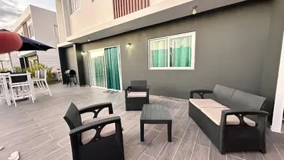 a patio with chairs and a couch and tables at VILLA 127 La Intensa Del Caribe in Pueblo Bavaro