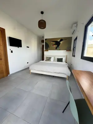 a bedroom with a bed and a tv on the wall at SunSeaBeach Villa Iguana - 3 SZ - Strandnähe in Las Galeras